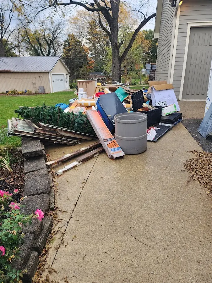 Dumpster being loaded with debris for 10 Yard Dumpster Rental in Spanaway